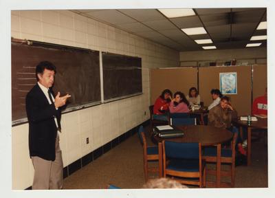 Students listen to a male professor during a lecture