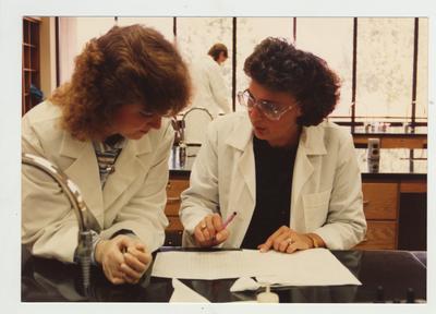 Female students perform an experiment in a laboratory
