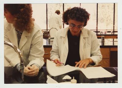 Female students perform an experiment in a laboratory