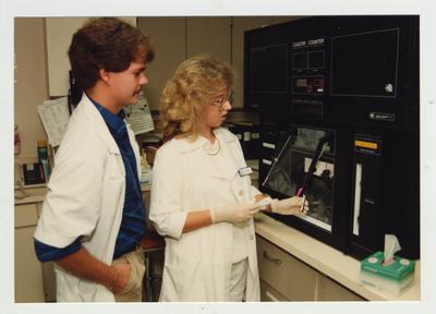 A woman and man work in a laboratory