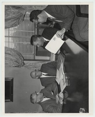Dean Shaver, Comptroller Peterson, President Dickey, and Merl Baker of Research Foundation possibly discussing the Indonesian Contract