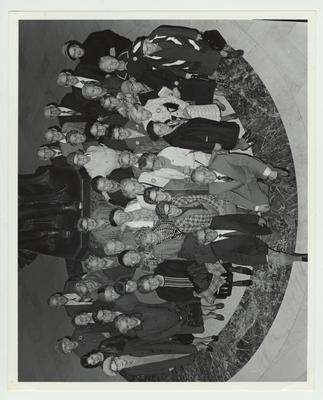 Lieutenant Governor Julian Carroll (kneeling in front on right), Earl Kaufman (director of the Council on Aging, kneeling in front on left), and other unidentified Donovan Scholars are standing at the capitol rotunda in Frankfort