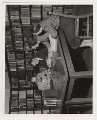 A group looks at books in the library