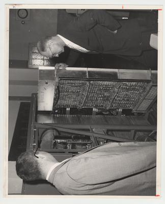 President Frank Dickey and John W. Hawbfeu, director of the computing center, examine a machine