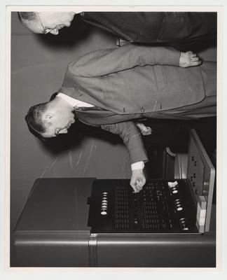 President Frank Dickey and Vice - President Leo M. Chamberlain examine a machine