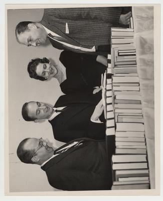 Laurence S. Thompson (far left), Joseph Rosenbloom (second from left), Mrs. Stanley Scher (second from right), and Irving Kanner (far right) look at books at the dedication of comparative religion of Temple Adafh Israel in Lexington, Kentucky; Lexington Herald - Leader staff photo