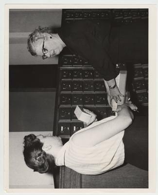 Ellen B. Stutsman (right), head of the catalog department in the University of Kentucky Libraries, is assisted by one of the members of her staff, Mildred Legg, shifts cards into the new catalog cases in the main Margaret I. King Library