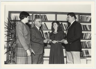 From left to right: Toni Powell, Paul Willis (director of libraries), and two unidentified students; Toni Powell is Director of Agricultural Library