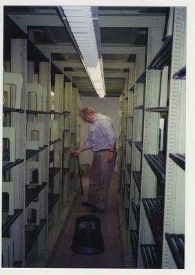 Jim Birchfield replacing a shelf in the core stacks after it was washed