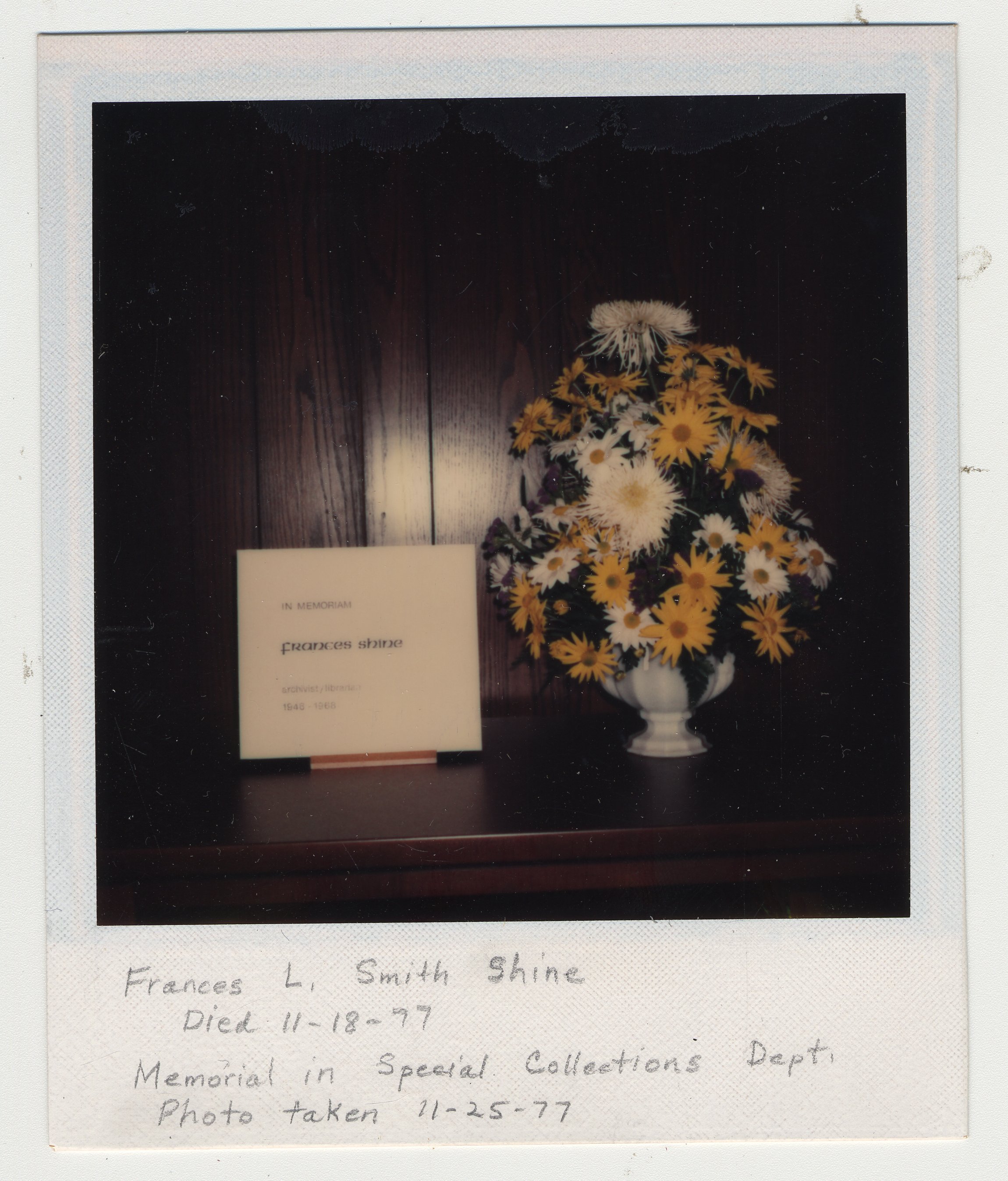 A flower arrangement sits beside a memorial in Special Collections that