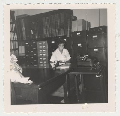 Jane Neff sits at the typewriter in the King Library on the fifth floor