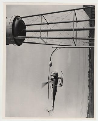 Men ride in a helicopter during the dedication of the Medical Center