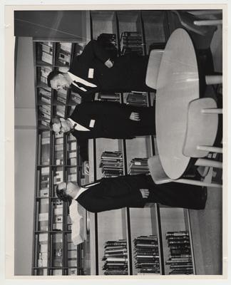 Men converse in the Medical Center Library at the Medical Center dedication