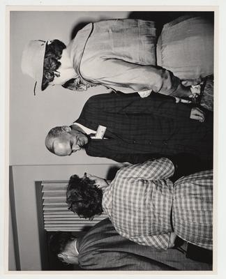 Dean William Willard (center) shakes hands with an unidentified woman at the Medical Center dedication while two other women look on