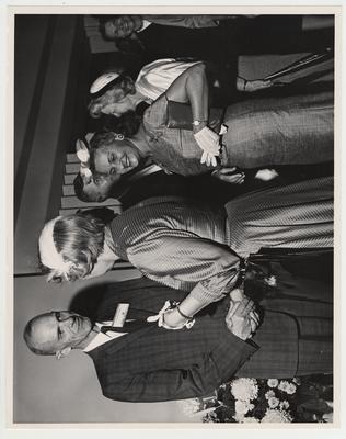 Dean William Willard (left) and President Frank Dickey (center) shakes hands with an unidentified woman