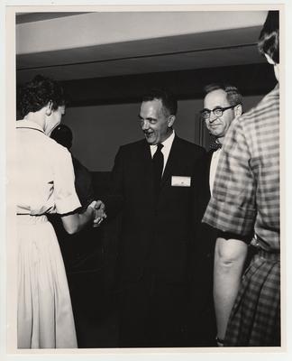 Dr. Frank Rogers (center) and another man shakes hands with two unidentified women at the Medical Center dedication