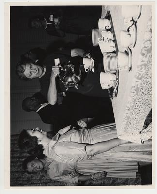 Mrs. Chamberlain (center) pours coffee for Dr. Judith Pratt, Associate Professor of Nursing (left) at a reception after the Medical Center dedication