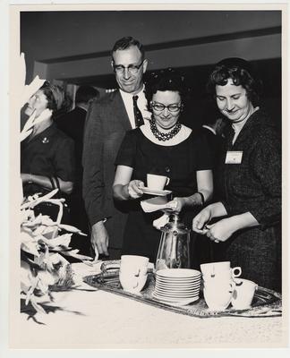 Mrs. Jesse Martin (right) and an unidentified man and woman get coffee at a reception after the Medical Center dedication
