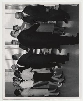 Medical Center Dentistry dedication; President Dickey (second from right), Mrs. Elizabeth Dickey (third from right), Dean William Willard (fourth from right), and unidentified others stand shaking hands