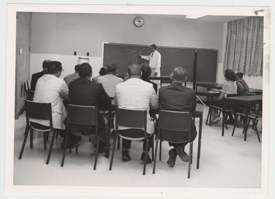 Dr. Stephen F. Dachi, Chairman of Oral Diagnosis and Oral Medicine, instructs a class in post graduate education; A continuing education program of short refresher courses for the dentists of Kentucky was activated in 1961