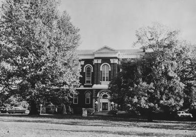 Administration Building with trees and cannon on front lawn; photographer:  John Mitchell