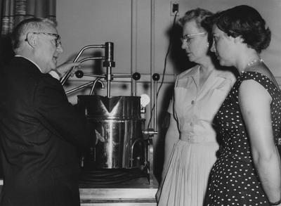 Dr. Hull (?, left) shows a machine to Marie Fortenberry (center) and an unidentified woman; Lexington Herald-Leader photo