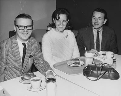 Three unidentified students eating lunch