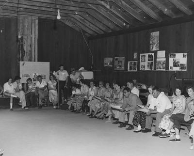 Camp Robinson; Unidentified people seated in building at Camp Robinson