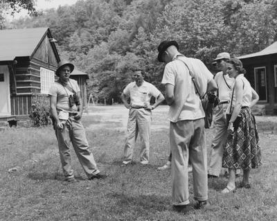 Camp Robinson; Roger Barbour, left, assistant professor of zoology at UK, briefs a group of staff members and students before a field trip into the surrounding Robinson Forest territory; from left (facing camera), R. D. Johnson, UK College of Adult and Extension Education, Francis Bush, graduate student, C. Dana Combs, student, and Jean Marie McConnell, staff member