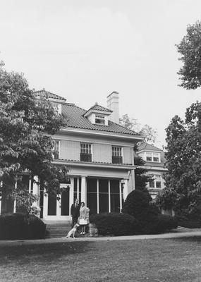 Carnahan House exterior with two unidentified individuals and dalmation on front steps; photographer:  Michael Koenig