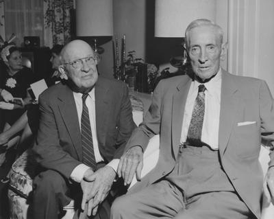 James W. Carnahan (right) talking with unidentified man at reception for Carnahan House dedication