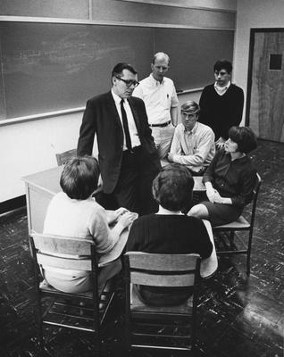 A class having a discussion with an unidentified teacher. Received from Public Relations