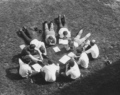 Unidentified students are having class outdoors. Many professors hold class outside the classroom when the weather permits. This photo appears first on page 132 of the 1969 
