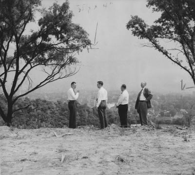 Dr. Thomas L. Hankins, Dr. Frank Dickey, Allan Land, and Dr. Frank Peterson inspect Devou Park, future site of educational plant. Received June 13, 1959 from Cincinnati-Enquirer