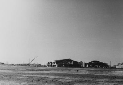 A sepia tone photo of the construction of buildings for Owensboro Community College. Owensboro Community College opened for classes in the fall of 1984. This photo was donated by Larry S. Miller, Dean of Student Affairs at Owensboro Community College. At the time of donation, the address read: Owensboro Community College, 920 Frederica Street, Owensboro, Kentucky 42301-3050 (address may have changed due to new constructions)
