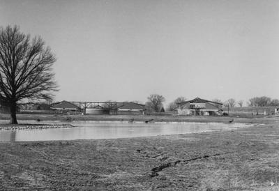 A sepia tone photo of the construction of buildings for Owensboro Community College. Owensboro Community College opened for classes in the fall of 1984. This photo was donated by Larry S. Miller, Dean of Student Affairs at Owensboro Community College. At the time of donation, the address read: Owensboro Community College, 920 Frederica Street, Owensboro, Kentucky 42301-3050 (address may have changed due to new constructions)