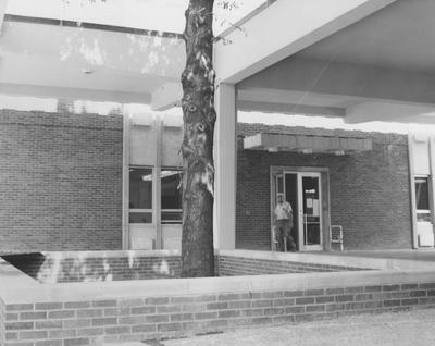 A man walking out one of the side doors of the Dickey Hall Building. Dickey Hall was first used during the fall semester of 1964-1965 college semester