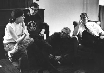 Four unidentified students are talking in the living room of the Dillard House. This photo is second on page 201 of the 1969 