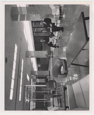 Men and women sit in a lobby of the Medical Center; Lexington Herald - Leader staff photo