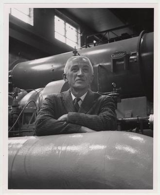 A man stands in a machine room; Lexington Herald - Leader staff photo