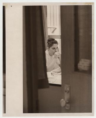 A female nurse sits at a desk