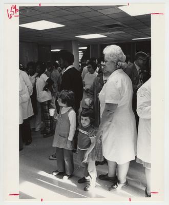 Men, women, and children at a Christmas party at the Medical Center