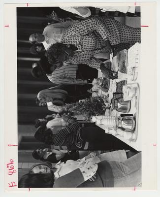 A crowd of employees at a Christmas party includes Jennie Taylor, Virginia Newby, James Taylor, and Tom Seward
