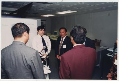 Visitors from Shandong University Medical School in Shandong Ji ' Den, China listening to an unidentified man in the Medical Center