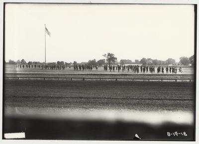 University of Kentucky military technical training during World War I.  Cadets in a field with the American flag