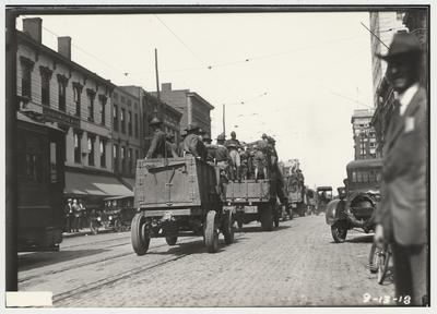 University of Kentucky military training during World War I.  Military trucks driving on Main Street past Graves and Cox department store on Main Street in Lexington