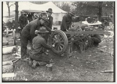 University of Kentucky military training during World War I.  Greasing the wheels of a car