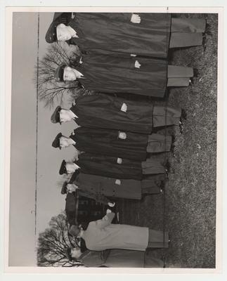 Men in uniform standing at attention.  The second person from the right is John Darsy