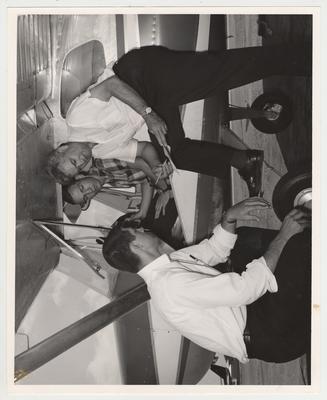 Final flight exams.  In the plane is Tommy Tompkins and Elbert McGregor.  Near the plane is Jim Thornton