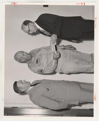 From the right:  Dean of Arts and Sciences, Martin M. White, Master Sergeant Morgan, and an unknown officer